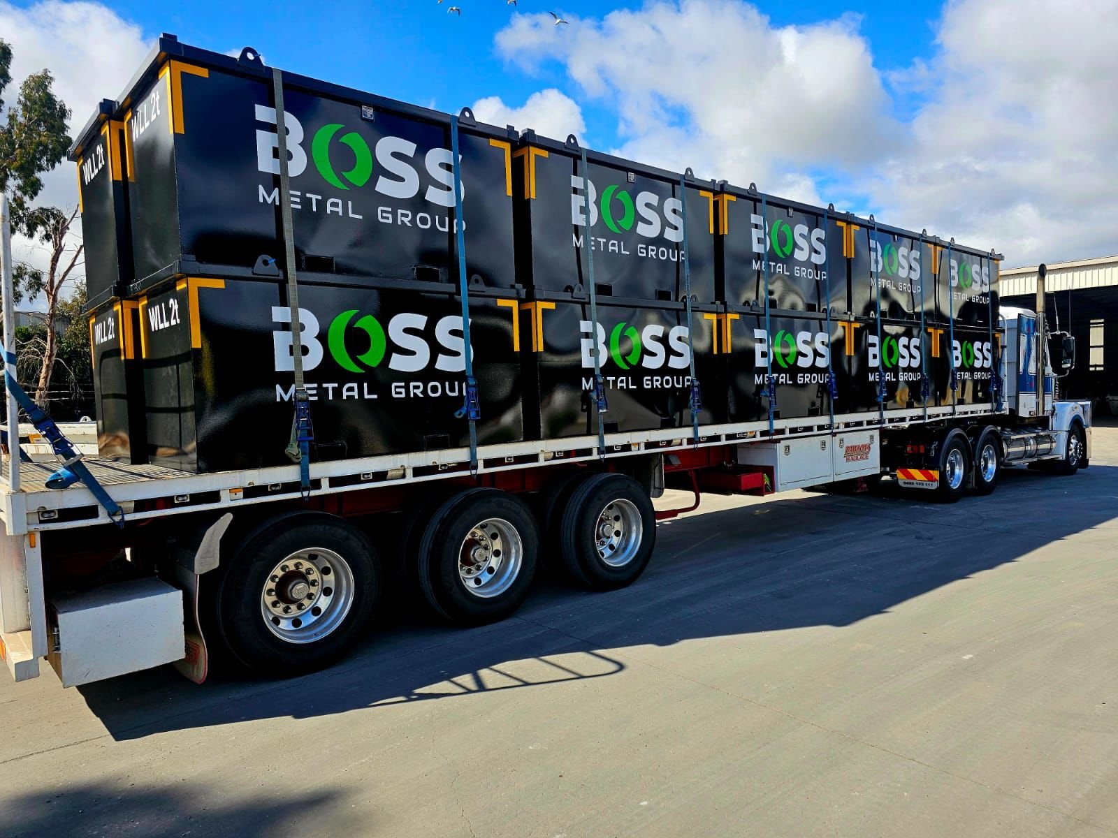 Truck loaded with metal containers.